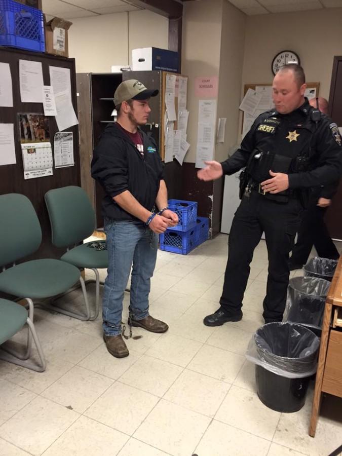 Reporter Lyle Grant is shackled in the Transportation Unit Offices of the Erie County Sheriffs Office