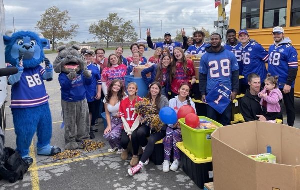 Students at drop-off day with players from the Buffalo Bills.